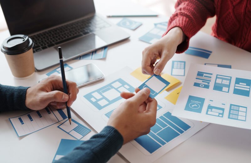 Designer, programmers, developers of mobile applications work together to invent a modern mobile application system.