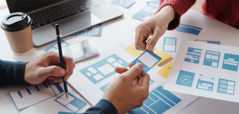 Designer, programmers, developers of mobile applications work together to invent a modern mobile application system.