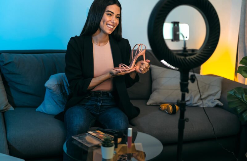 Female influencer vlogging online with smartphone cam and ring led from home - Youth people with social media and smart working concept