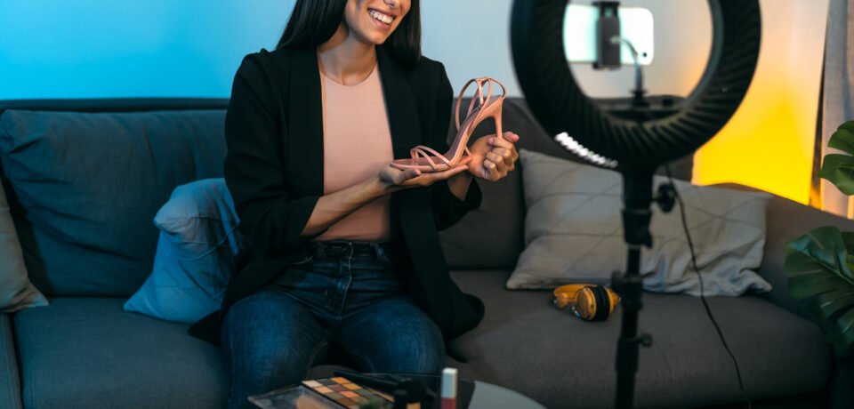 Female influencer vlogging online with smartphone cam and ring led from home - Youth people with social media and smart working concept